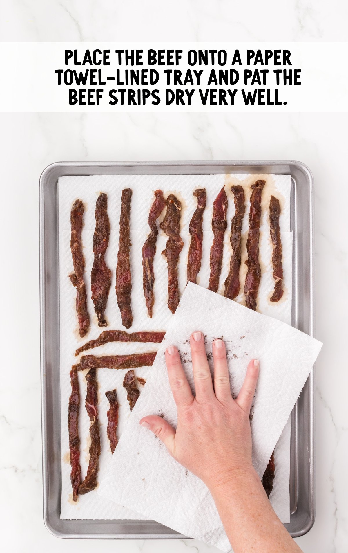 beef placed onto a paper towel-lined tray