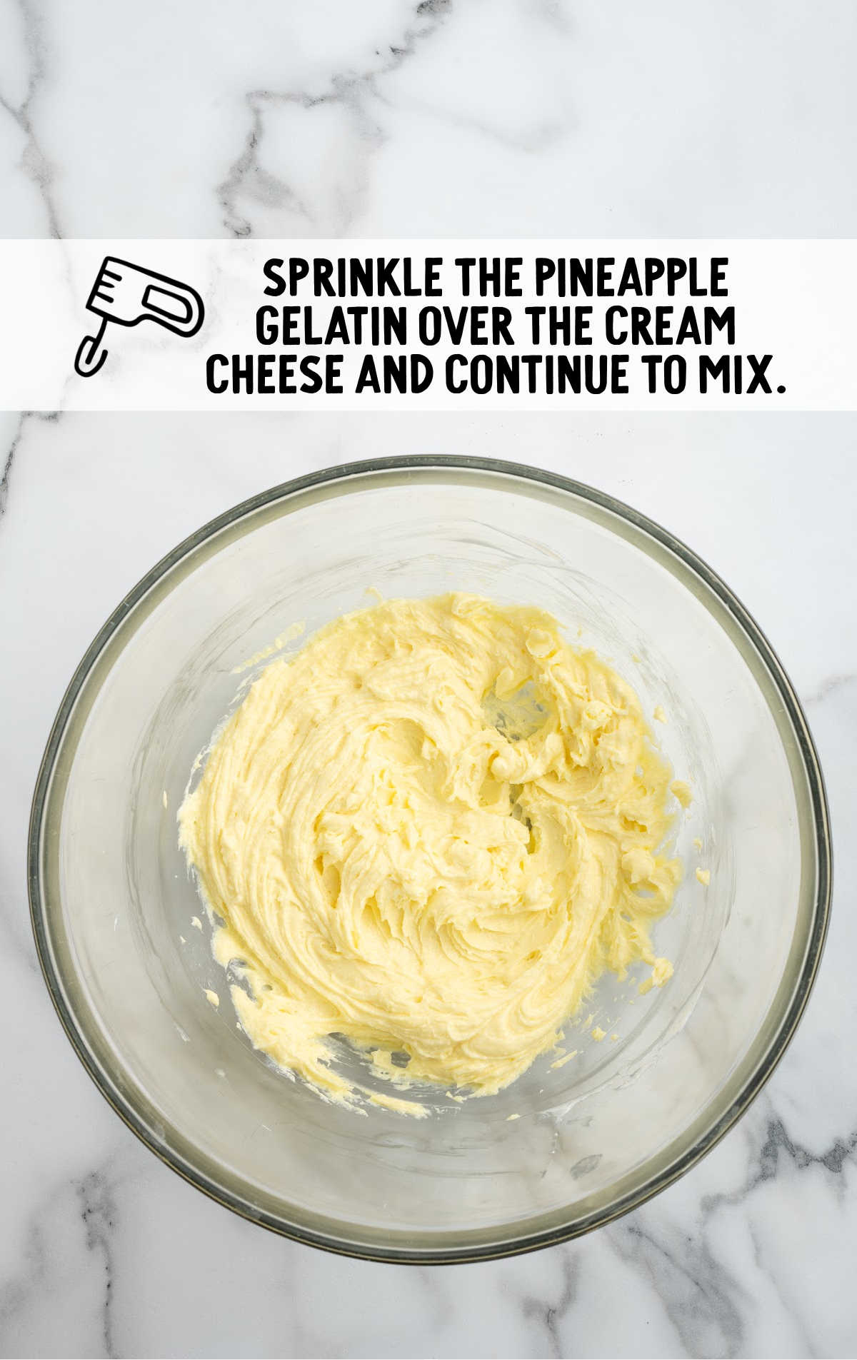 pineapple gelatin combined with the cream cheese in a bowl