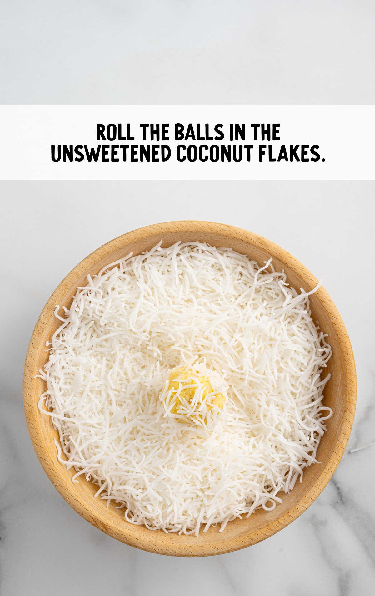 balls rolled into the unsweetened coconut flakes