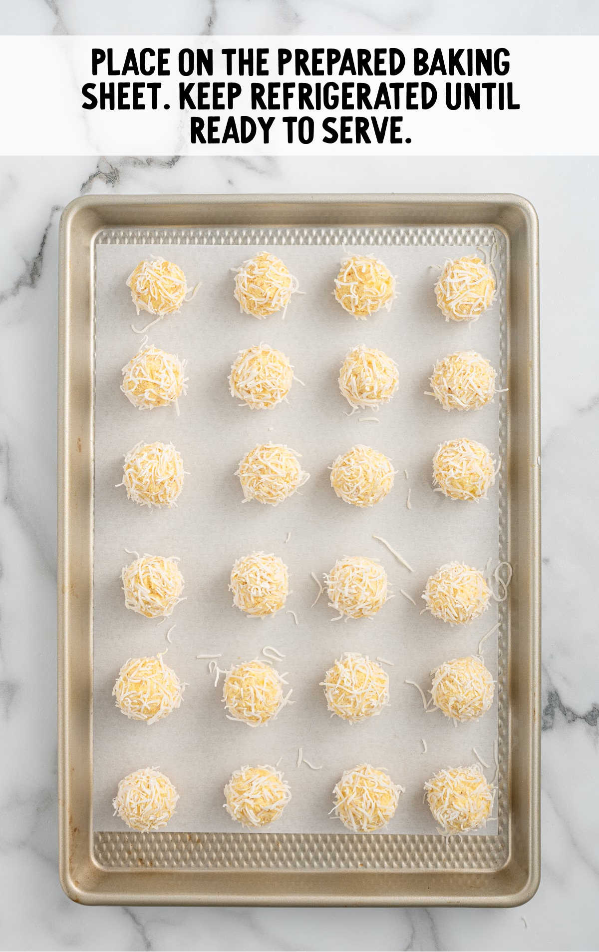 pineapple balls on a parchment lined baking sheet