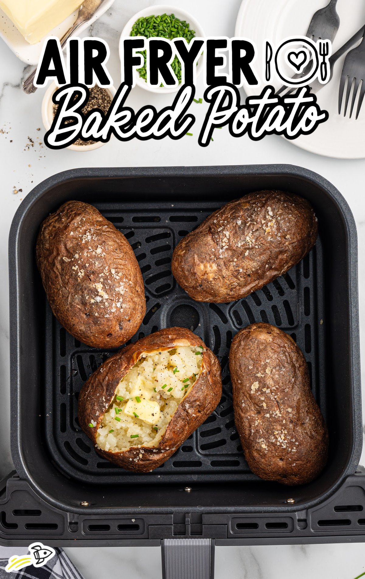 a baked potato topped with chives in a air fryer