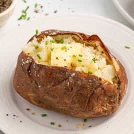 a baked potato topped with chives