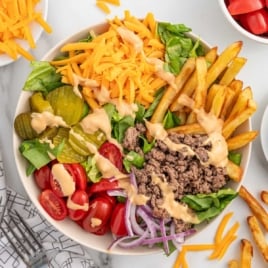 a burger bowl drizzled with sauce