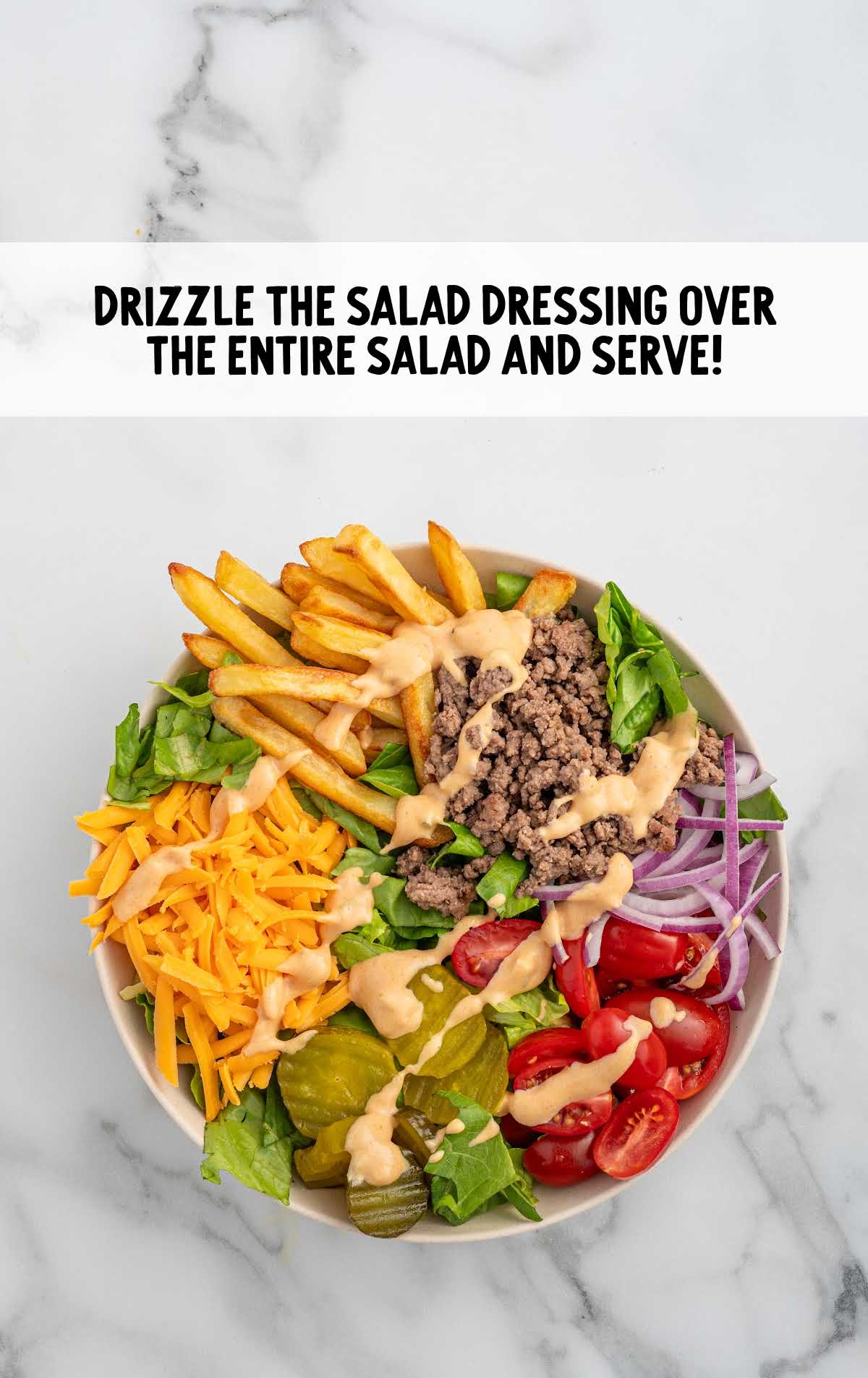 salad dressing drizzled on top of the burger bowl