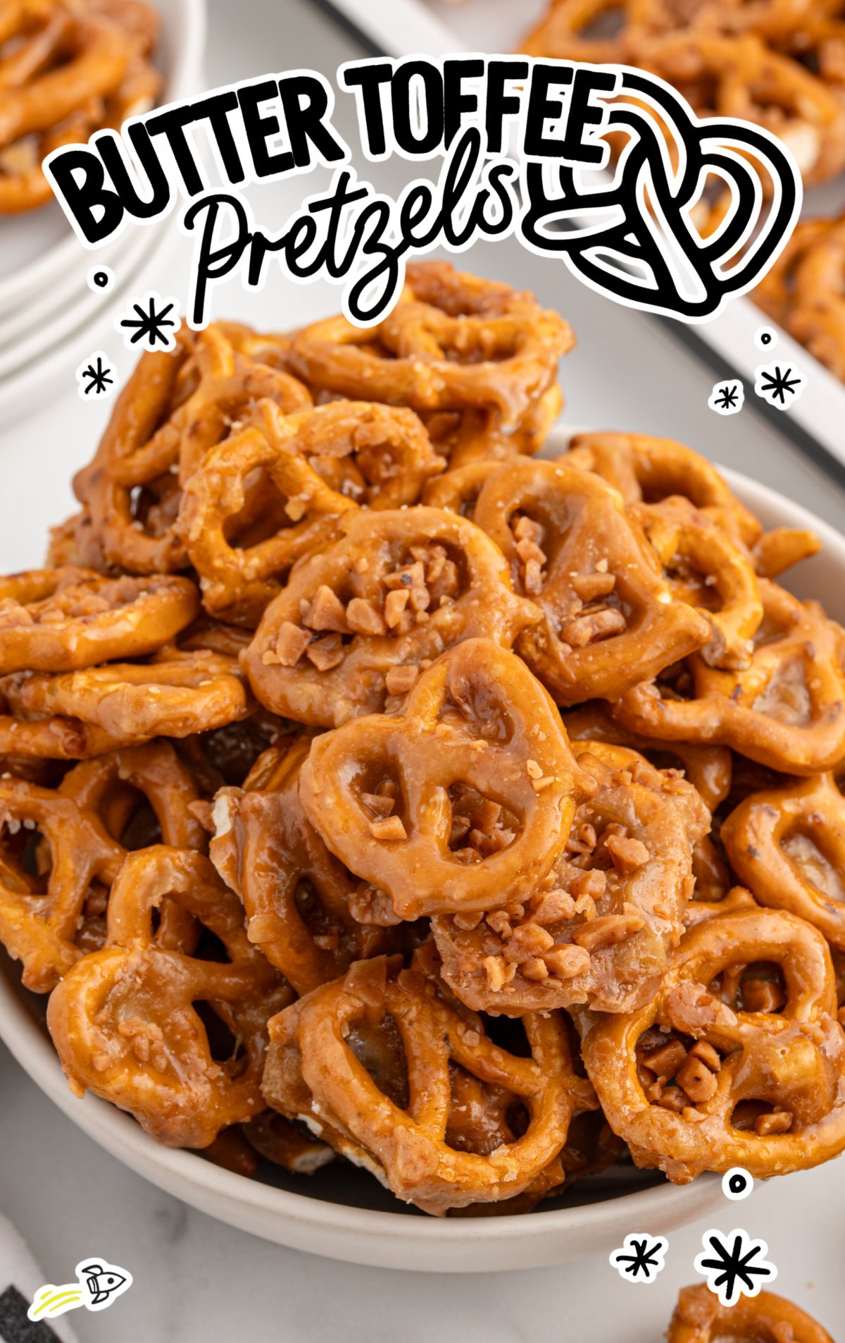 a white bowl full of butter toffee pretzels