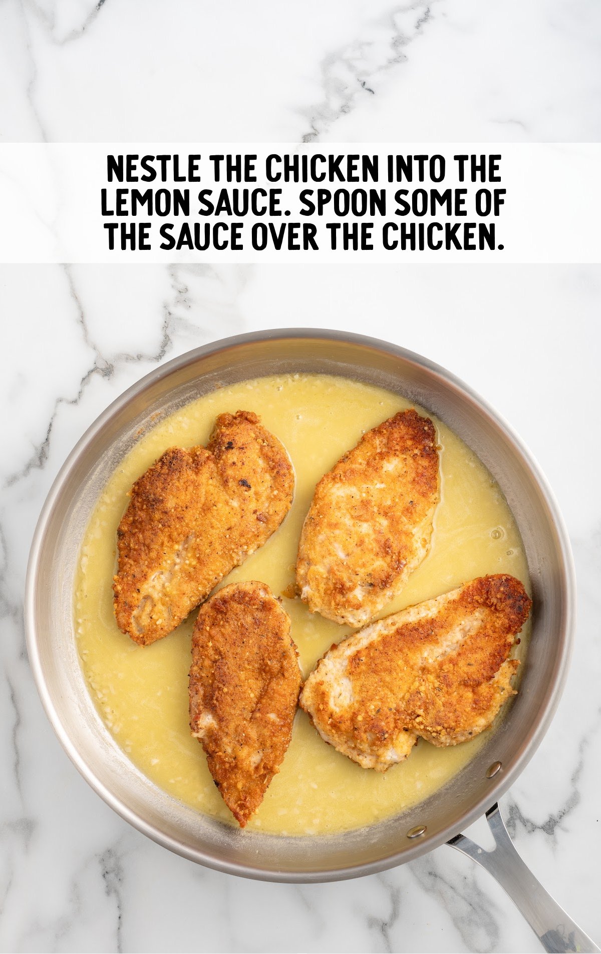 chicken placed into the lemon sauce