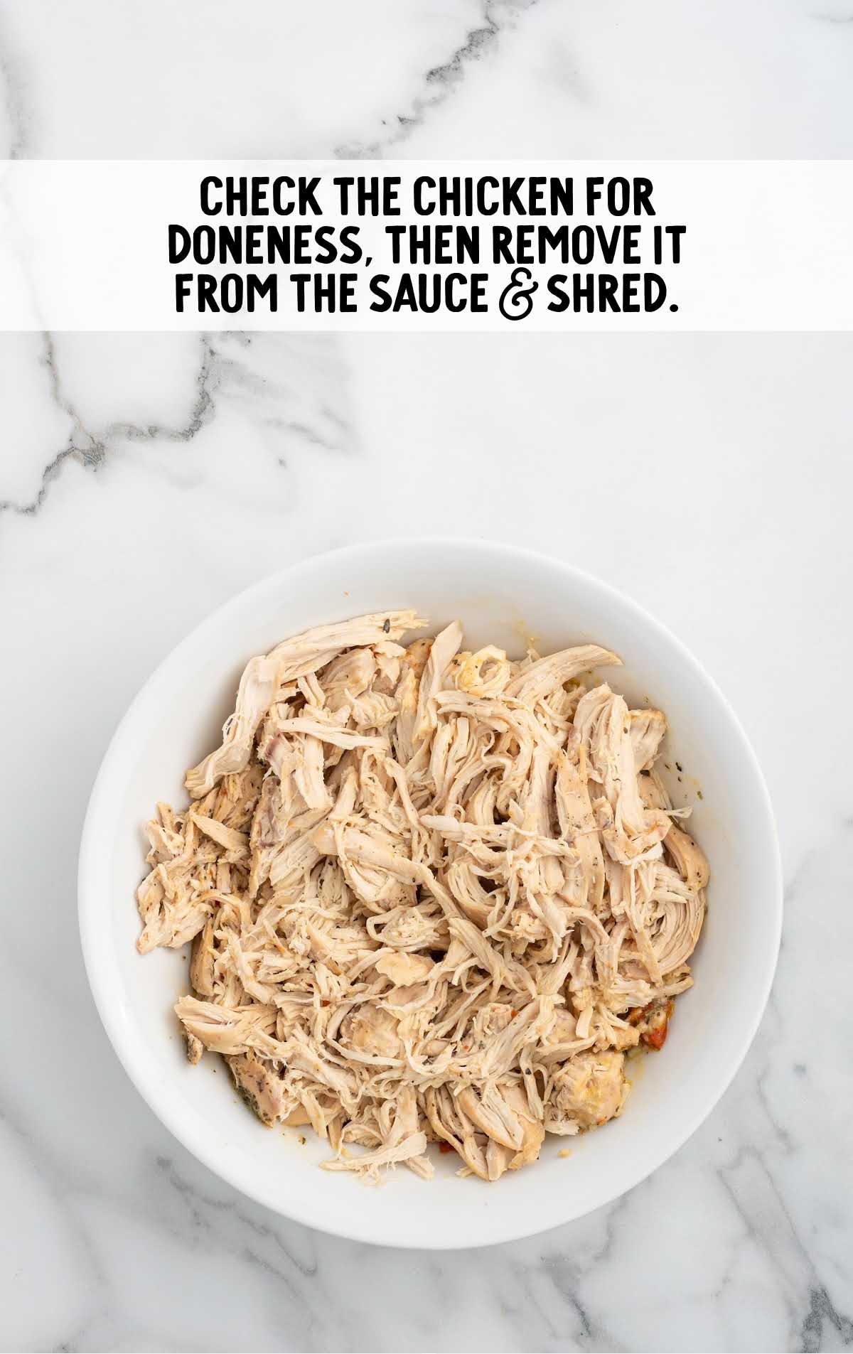 cooked chicken shredded in a bowl