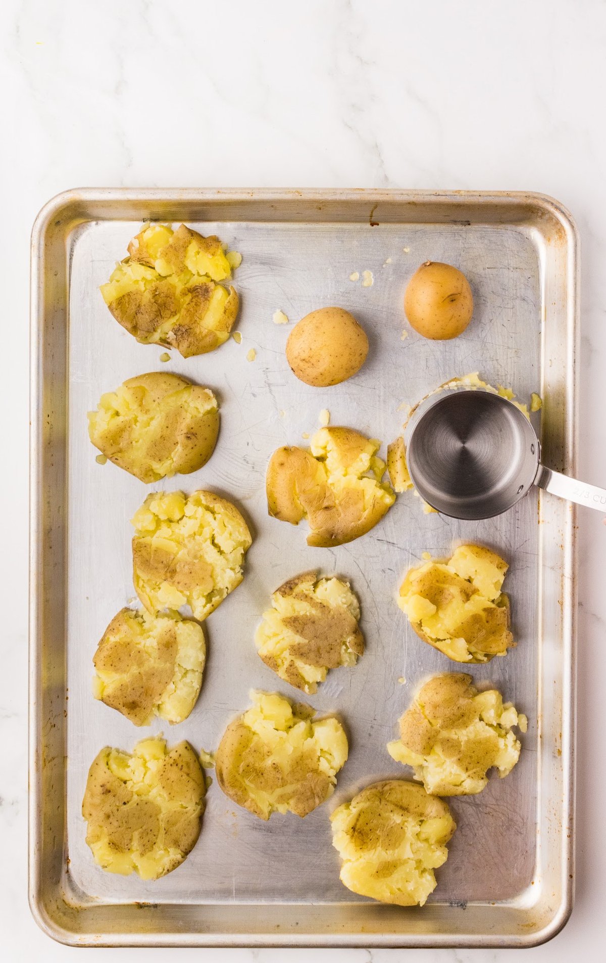 Crispy Smashed Potatoes smashed on a baking sheet