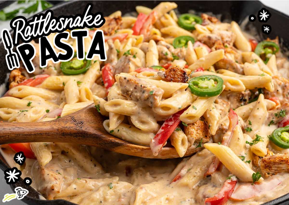 skillet of creamy rattlesnake pasta with penne, chicken pieces, jalape&ntilde;os, and red bell peppers