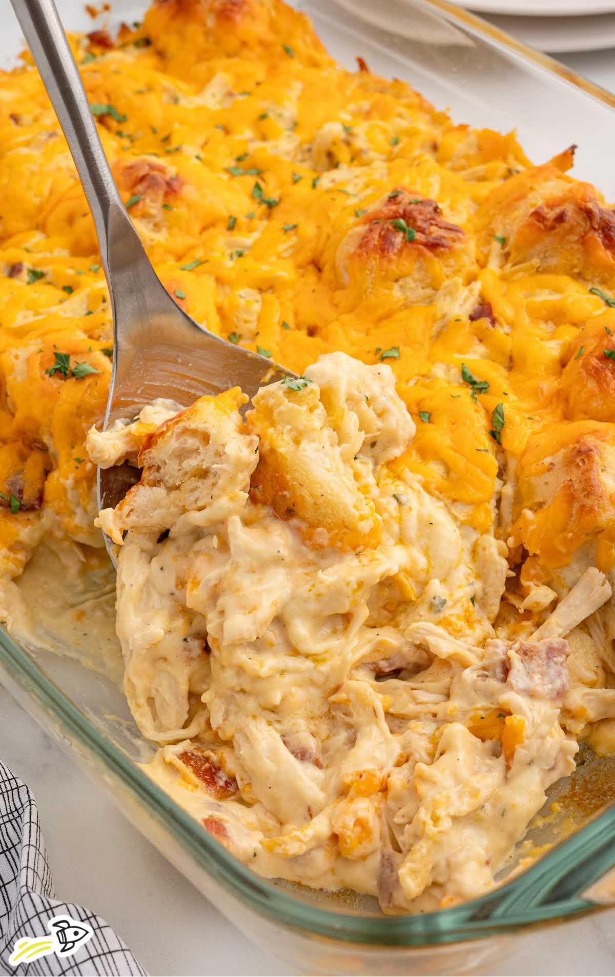 a baking dish of chicken bubble biscuit bake garnished with parsley