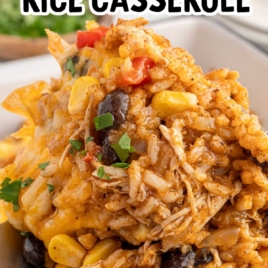 A vertical image of chicken enchilada rice casserole being served from a baking dish, featuring the text "Feeds a Crowd" and "Easy & Hearty Dinner!"