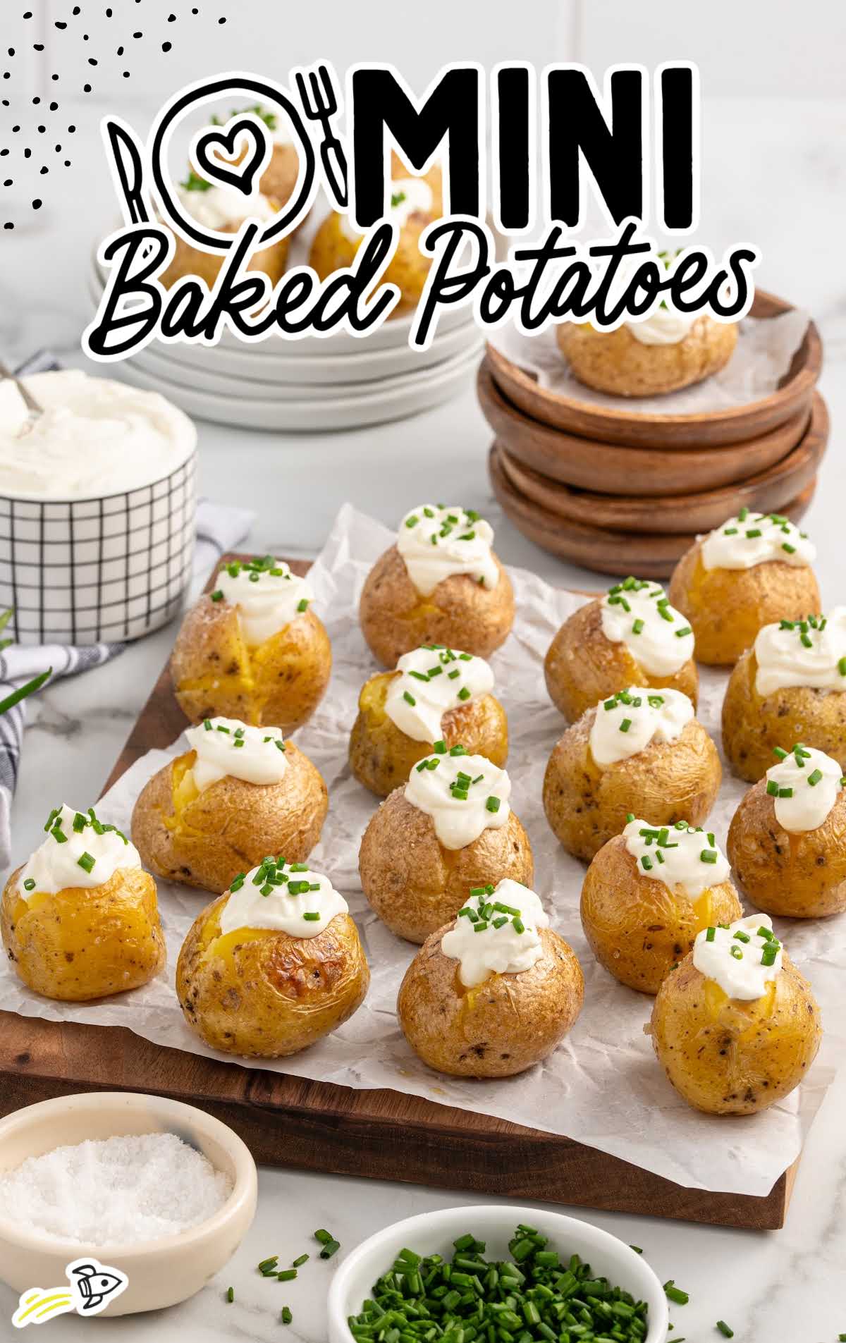 a bunch of mini baked potatoes topped with sour cream and chives