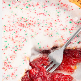 strawberry pop tart pie with a fork in the oozing filling.