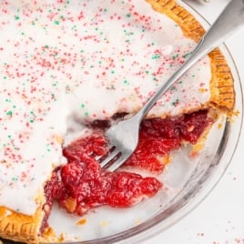 A strawberry pop tart pie with a fork in a glass pie plate.