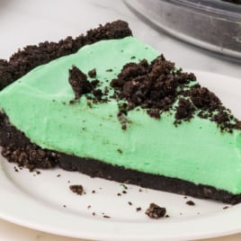 A slice of Grasshopper Pie on a white dessert plate.