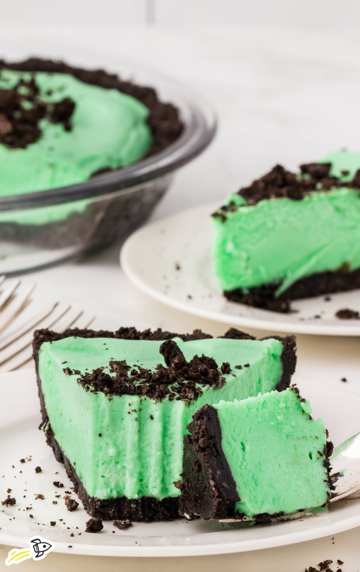 A piece of Grasshopper Pie on a white plate with a fork.