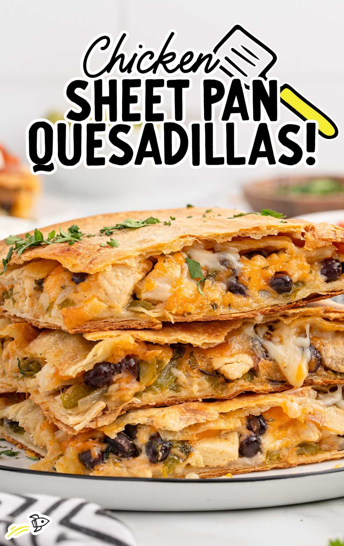 A graphic image featuring "Chicken Sheet Pan Quesadillas!" text with a stack of cheesy quesadilla slices in the background.