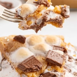 Easy recipe for s'mores pie, featuring a whole pie with melted chocolate, marshmallows, and graham cracker crust.