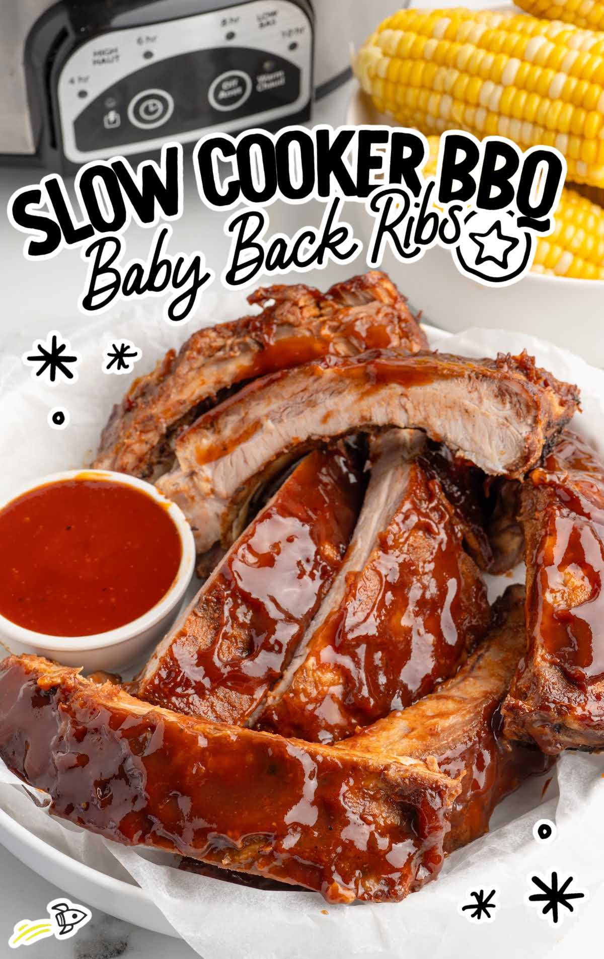 Slow cooker BBQ baby back ribs glazed with barbecue sauce and sliced into portions on a serving platter