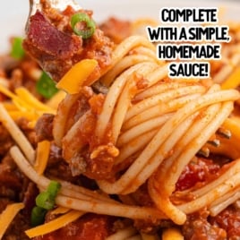 Fork holding a bite of cowboy spaghetti with bacon, cheddar, and green onions, text overlay reads “Cowboy Spaghetti (Easy Recipe!) Complete with a Simple, Homemade Sauce!”