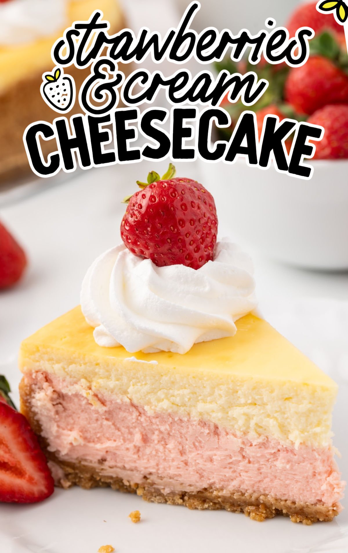Close-up of a slice of strawberries and cream cheesecake with a graham cracker crust, swirled whipped cream, and a whole strawberry on top, with text overlay reading "Strawberries & Cream Cheesecake."
