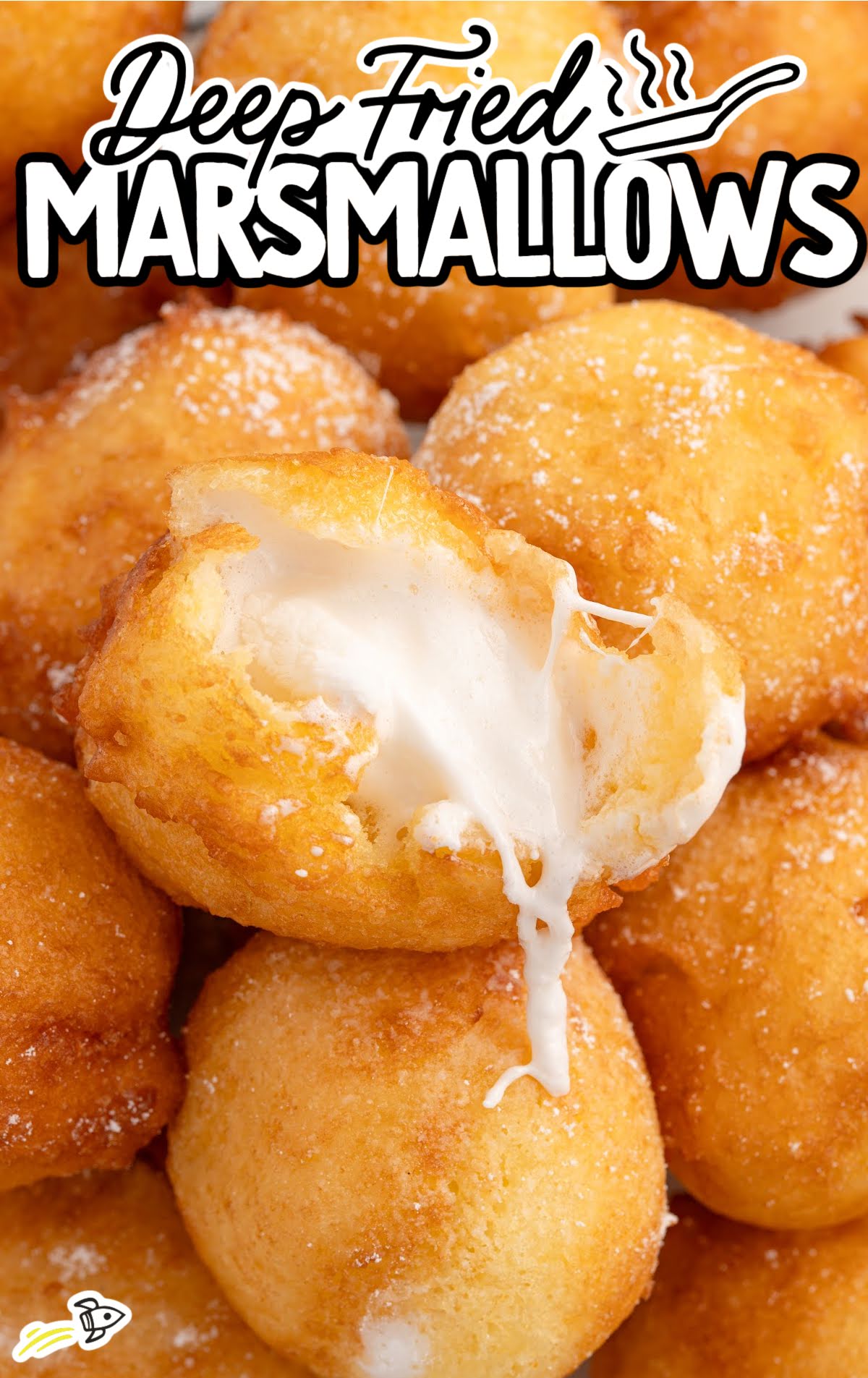 Plate of deep-fried marshmallows with one bitten open, revealing melted inside.