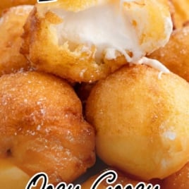 Gooey deep-fried marshmallow split open on top of a plate of golden marshmallows, labeled “Easy with Pancake Mix – Ooey Gooey Deep Fried Marshmallows.”