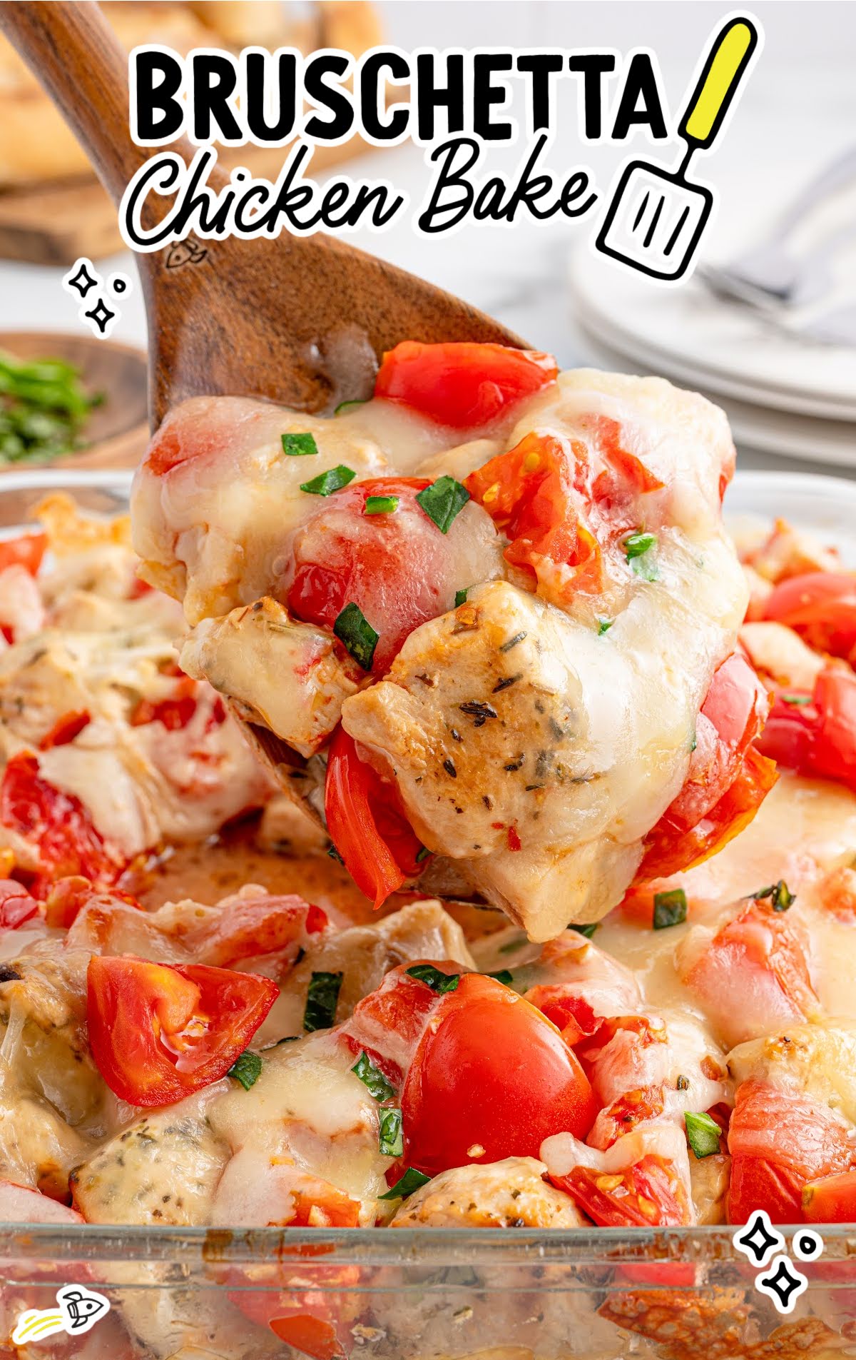 Close-up of a spoonful of bruschetta chicken bake with gooey melted cheese, chunks of tomato, and browned chicken, with title text overlaid.
