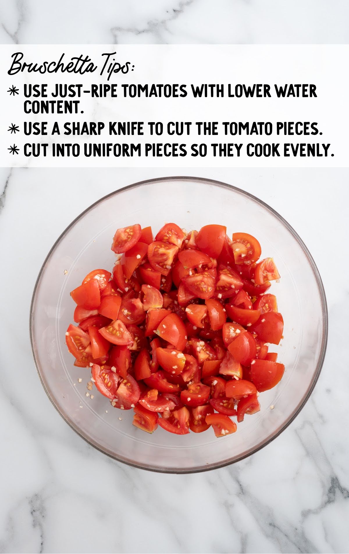 Bowl of uniformly chopped fresh tomatoes mixed with garlic, shown under bruschetta preparation tips on a marble background.
