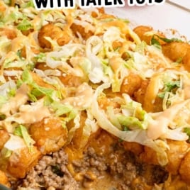 Big Mac tater tot casserole in a glass dish topped with lettuce and sesame seeds, labeled as casserole with all the flavors of a Big Mac.