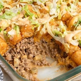Overhead of Big Mac tater tot casserole topped with shredded lettuce and special sauce.