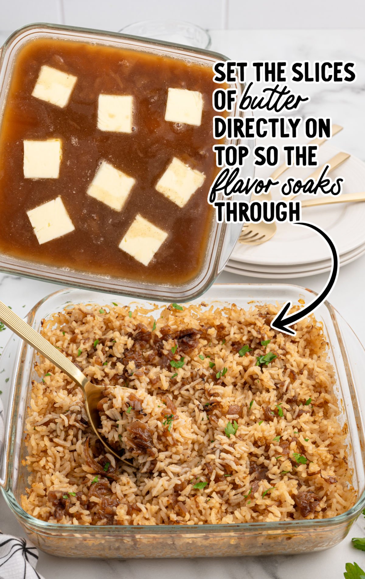 Unbaked French onion rice in casserole dish topped with cubes of butter before baking.