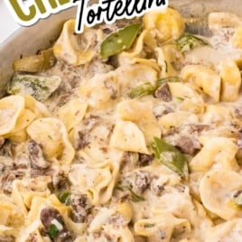 Philly cheesesteak tortellini skillet filled with cheese tortellini, steak, peppers, and a creamy sauce topped with melted cheese