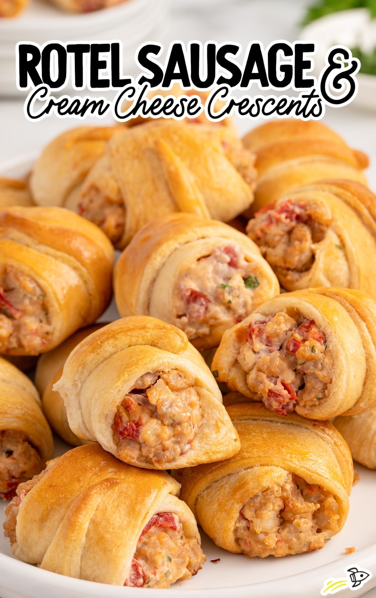 Bowl of golden Rotel sausage and cream cheese crescents showing the creamy, slightly spicy sausage filling.