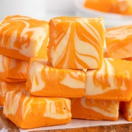 Orange creamsicle fudge squares with vibrant orange color and creamy white swirl pattern