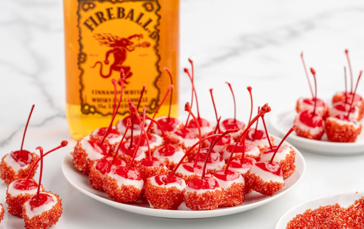 Overhead shot of Fireball cherry bomb ingredients displayed with Fireball whiskey and Wilton candy melts.