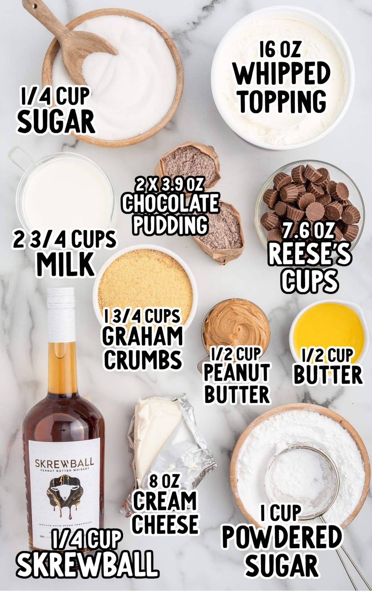 Overhead photo of Skrewball lasagna ingredients including Skrewball whiskey, peanut butter, cream cheese, chocolate pudding, whipped topping, milk, sugar, graham crumbs, and Reese’s cups.