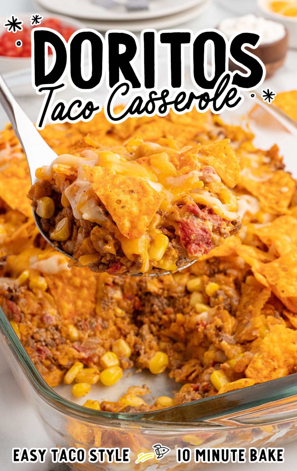 Scoop of Doritos taco casserole with stretchy melted cheese lifted from a baking dish