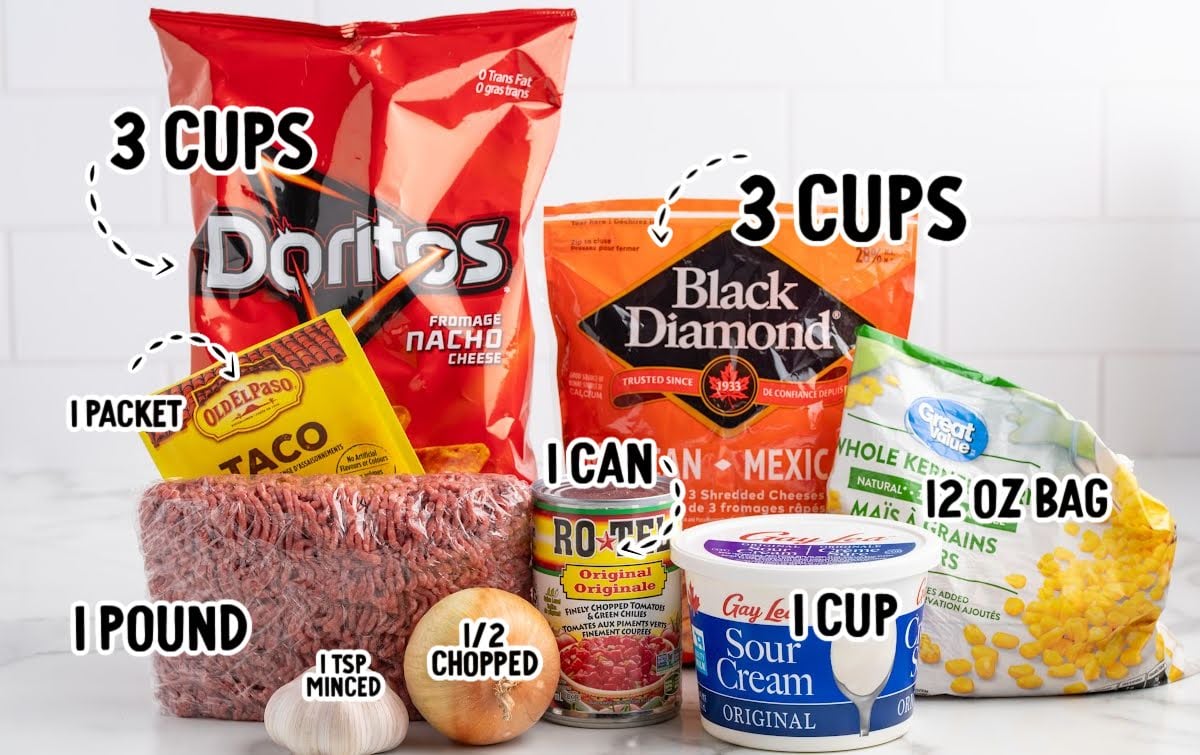 Ingredients for Doritos taco casserole including ground beef, Doritos, shredded cheese, sour cream, Rotel, and corn