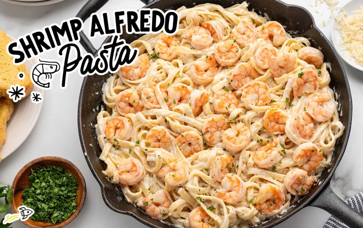 Shrimp alfredo pasta with fettuccine noodles served in a cast iron skillet