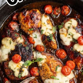 Close-up of balsamic chicken topped with melted cheese and blistered cherry tomatoes with a glossy balsamic glaze.