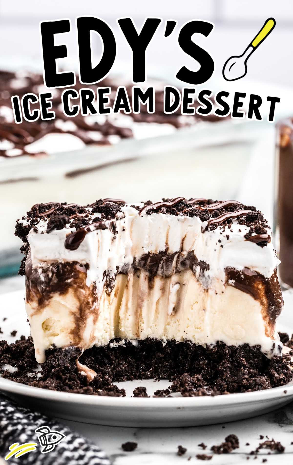 a slice of ice cream dessert on a plate with a piece taken out of it with a fork