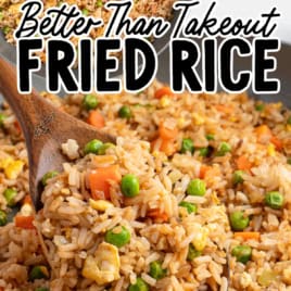 A close-up of fried rice with peas, carrots, egg, and green onion in a pan as a wooden spoon scoops some up. Text reads Vintage Recipe! Try this Better Than Take-Out Fried Rice for an easy homemade favorite.
